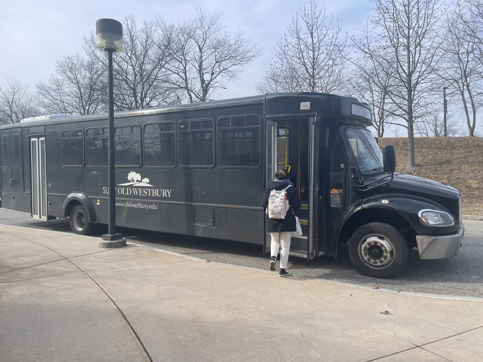 A black bus parked on the side of a road

Description automatically generated