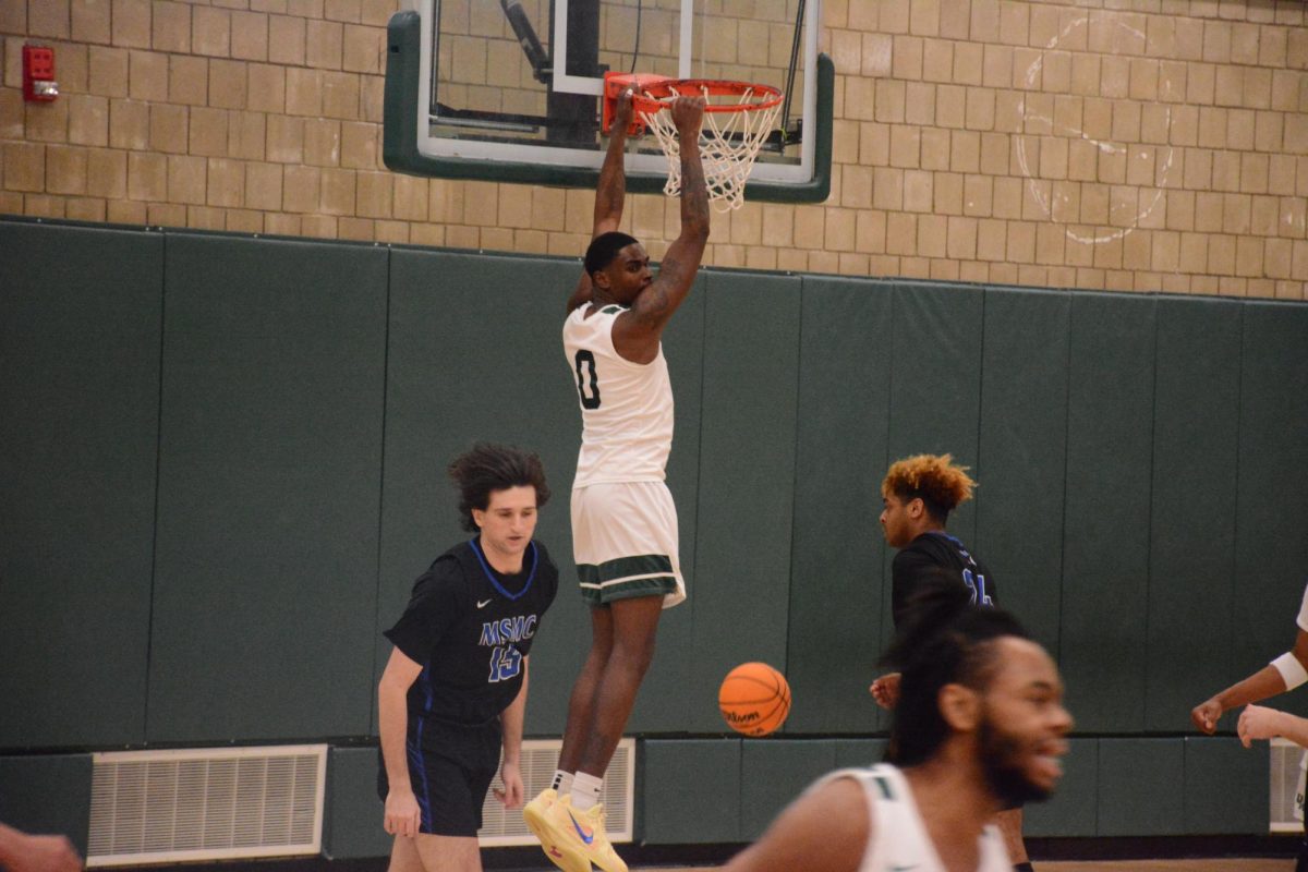 Jamari Williams pictured hanging from the rim.
Photo Credit: Old Westbury Athletic Communications