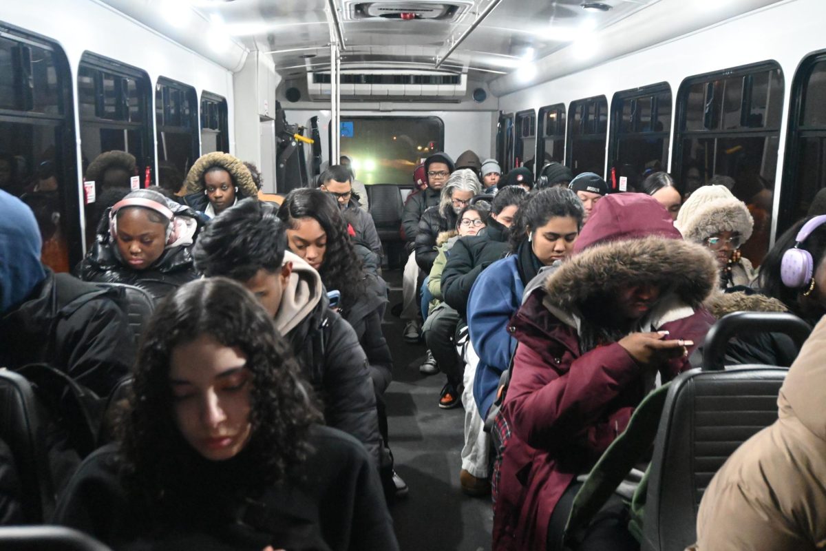 During evening hours a crowded shuttle bus with SUNY Old Westbury students sitting down looking at their phones after a long journey in class at 6:46 p.m. on their way to the Hicksville train station on Feb. 17, 2026. PHOTO BY: CIHARA JAIMES