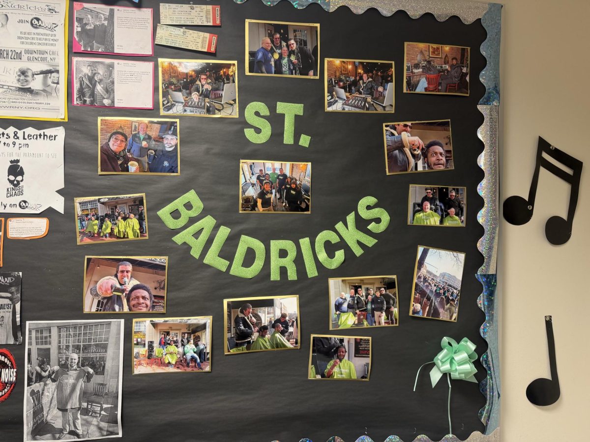A bulletin board with pictures from St. Baldrick's 2025, made by Angelina Zavala, on the second floor of the Student Union at SUNY Old Westbury, on Mar. 10, 2026. PHOTO BY: KATHERINE CAMPBELL