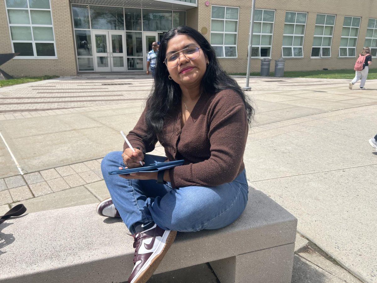 Genesis Telles, a junior at SUNY Old Westbury, outside the New Academic Building on April 29, 2025. PHOTO BY: ANGELES NERI