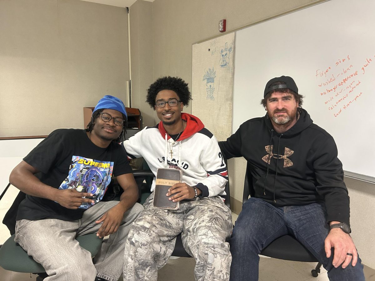 Zechariah Davis (left), Devon Duncan (center), vice president of Cru, and Nathen Walden (right) meet in a conference room at the Student Union on April 29, 2026, at SUNY Old Westbury. The group gathered to discuss the upcoming Cru Bible study event. PHOTO BY: JULIA WALTER