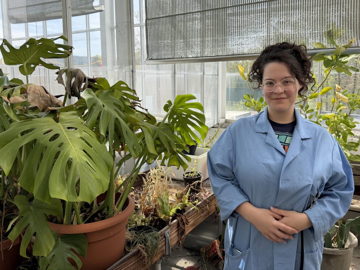 Nikki Rodgers, a Lab Technician at SUNY Old Westbury, standing in front of her plants in the Campus Greenhouse on Apr. 28, 2026. PHOTO BY: KORRINA PLAIR